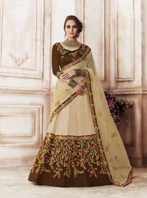 Flaunt Your Rich And Elegant Taste Wearing This Heavy Designer Lehenga Choli In Brown Colored Blouse Paired With Beige Colored Lehenga And Dupatta. This Lehenga Choli Is Fabricated On Art Silk Paired With Net Fabricated Dupatta. Buy Now.