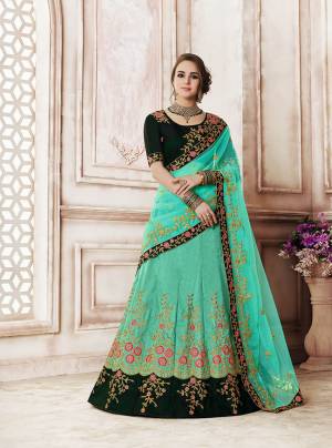 New And Unique Color Pallete Is Here With This Heavy Designer Lehenga Choli In Pine Green Colored Blouse Paired With Contrasting Turquoise Blue Colored Lehenga And Dupatta. Its Contrasting Embroidery Will Give An Attractive Look. 