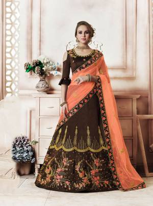 Another Rich Color Pallete Is Here With This Designer Lehenga Choli In Brown Color Paired With Contrasting Dark Peach Colored Dupatta. This Lehenga Choli Is Silk Based Paired With Net Fabricated Dupatta. Buy This Now. 