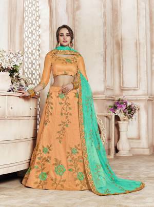 Catch All The Limelight Wearing This Heavy Designer Lehenga Choli In Peach Color Paired With Contrasting Sea Green Colored Dupatta. Its Blouse And Lehenga Are Silk Based Paired With Net Fabricated Dupatta. Its Rich Fabric And Color Pallete Will Earn You Lots Of Compliments From Onlookers. 