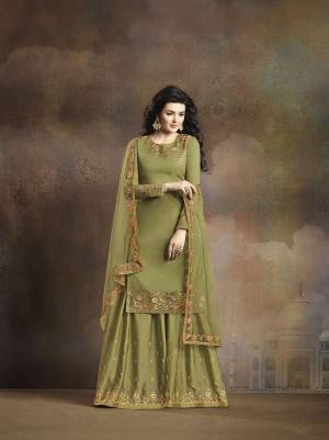 Very Beautiful And Rich Shade Is Here With This Heavy Designer Suit In Olive Green Color. Its Top And Bottom are Fabricated On Soft Silk Paired With Net Fabricated Dupatta. Its Has Contrasting Embroidery Over Top, bottom And Dupatta Which Gives An Attractive Look To The Suit. 