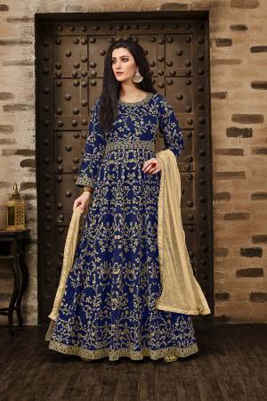 Here Is A Beautiful Heavy Designer Floor Length Suit In Royal Blue Color Paired With Beige Colored Dupatta. Its Heavy Embroidered Floor Length Top Is Fabricated On Tafeta Silk Paired With Santoon Bottom And Net Fabricated Dupatta. Buy Now.