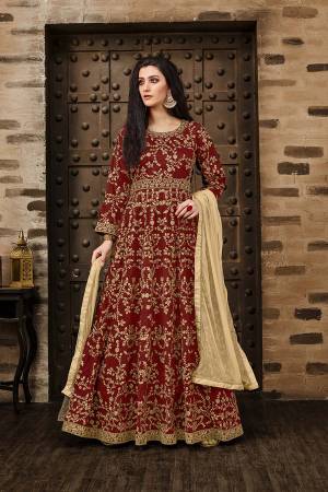 Here Is A Beautiful Heavy Designer Floor Length Suit In Red Color Paired With Beige Colored Dupatta. Its Heavy Embroidered Floor Length Top Is Fabricated On Tafeta Silk Paired With Santoon Bottom And Net Fabricated Dupatta. Buy Now.