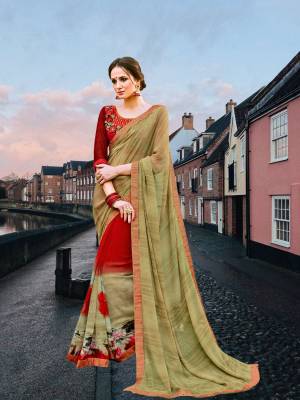 New Combination In Saree Is Here With This Mint Green And Red Colored Saree Paired With Red Colored Blouse. This Saree Is Fabricated On Georgette Paired With Art Silk Fabricated Blouse. It Has Lovely Prints Over The Saree And Embroidery Over The Blouse. 