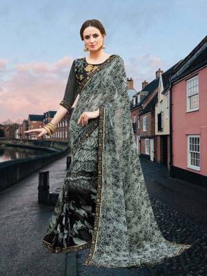Enhance your Beauty Wearing This Saree In Grey And Black Color Paired With Black Colored Blouse. This Saree Is Fabricated On Georgette Paired With Art Silk Fabricated Blouse. It Is Beautified With Prints all Over The Saree And Embroidery Over The Blouse. 