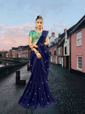 Bright And Visually Appealong Color Is Here With This Designer Saree In Royal Blue Color Paired With Contrasting Sea Green Colored Blouse. This Saree Is Fabricated On Georgette Paired With Art Silk Fabricated Blouse. It Has Heavy Embroidery Blouse And Pretty Small Buttis All Over The Saree. 
