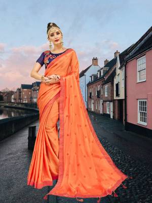 Celebrate This Festive Season With Beauty And Comfort Wearing This Designer Saree In Orange Color Paired With Contrasting Violet Colored Blouse. This Saree Is Georgette Based Beautified With Butti Work Paired With Art Silk Fabricated Blouse With Heavy Embroidery Work. 