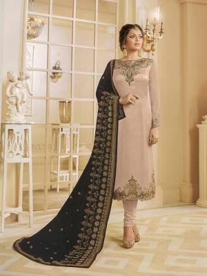 Simple And Elegant Looking Heavy Deisgner Straight Suit Is Here In Beige Color Paired With Black Colored Dupatta. This Rich And Bold Combination Will Earn You Lots Of Compliments From Onlookers. Its Top Is Fabricated On Satin Georgette Paired With Santoon Bottom And Georgette Fabricated Heavy Embroidered Dupatta. 