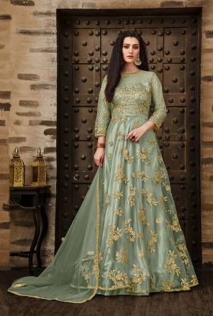 Grab This Very Pretty Deisgner Floor Length Suit In Pastel Green Color Paired With Pastel Green Colored Bottom And Dupatta. Its Heavy Embroidered Top Is Fabricated On Net Paired With Santoon Bottom And Net Fabrucated Dupatta Also It Comes With A Satin Fabricated Inner Which Gives An Olverall Attractive Look. Buy This Pretty Suit Now.