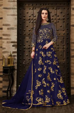 Grab This Very Pretty Deisgner Floor Length Suit In Royal Blue Color Paired With Royal Blue Colored Bottom And Dupatta. Its Heavy Embroidered Top Is Fabricated On Net Paired With Santoon Bottom And Net Fabrucated Dupatta Also It Comes With A Satin Fabricated Inner Which Gives An Olverall Attractive Look. Buy This Pretty Suit Now.