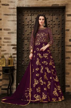 Grab This Very Pretty Deisgner Floor Length Suit In Wine Color Paired With Wine Colored Bottom And Dupatta. Its Heavy Embroidered Top Is Fabricated On Net Paired With Santoon Bottom And Net Fabrucated Dupatta Also It Comes With A Satin Fabricated Inner Which Gives An Olverall Attractive Look. Buy This Pretty Suit Now.