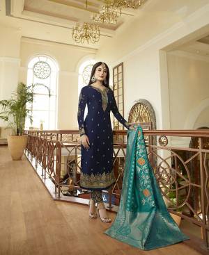 Enhance Your Personality Wearing This Heavy Designer Suit In Navy Blue Color Paired With Contrasting Turquoise Blue Colored Dupatta.. Its Top Is Fabricated On Satin Georgette Paired With Santoon Bottom And Jacquard Silk Fabricated Dupatta. Its Attractive Embroidery Over The Top And Bottom Will Earn You Lots Of Compliments From Onlookers. 