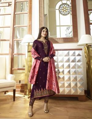 Pretty Attractive Color Pallete Is Here With This Heavy Designer Straight Suit In Purple Color Paired With Contrasting Pink Colored Dupatta. Its Top Is Fabricated On Satin Georgette Paired With Santoon Bottom And Jacquard Silk Fabricated Dupatta. Buy Now.