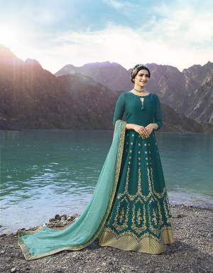 New Shade Is Here To Add Into Your Wardrobe With This Heavy Designer Floor Length Suit In Teal Blue Color Paired With Contrasting Turquoise Blue Colored Dupatta. Its Top Is Fabricated On Soft Silk Paired With Santoon Bottom And Georgette Fabricated Dupatta. Buy This Now. 