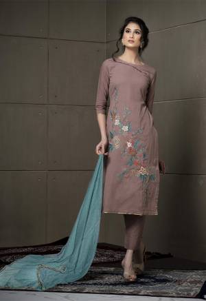 Another Unique Shade Is Here To Add Into Your Wardrobe With This Designer Straight Suit In Sand Grey Color Paired With Contrasting Light Blue Colored Dupatta. Its Top Is Fabricated On Cotton Linen Paired With Cotton Bottom And Chiffon Fabricated Dupatta, Grab Now.