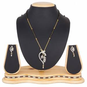 Here Is A New And Unique Patterned Designer Mangalsutra Set In Golden and Silver Color. This Pretty Set Comes A Pretty Pair Of Matching Earrings. It Is Beautified With Attractive Dimaond Work With Unique Designs. Buy Now.