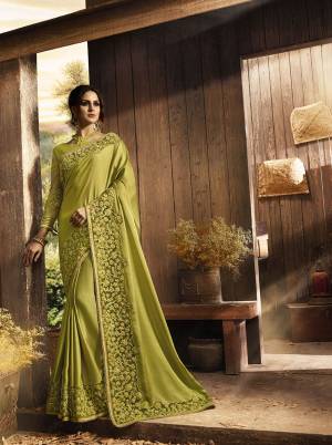 New And Unique Shade Is Here To Add Into Your Wardrobe With This Heavy Designer Saree In Pear Green Color Paired With Pear Green Colored Blouse. This Pretty Saree Is Fabricated On Soft Silk And Net Paired With Art Silk & Net Fabricated Blouse. It Is Beautified With Heavy Fancy Embroidery Over The Saree Border And Blouse. 