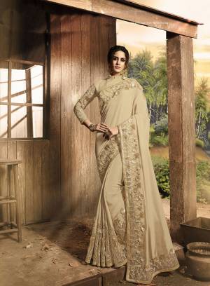 Flaunt Your Rich And Elegant Taste In This Heavy Designer Saree In Beige Color Paired With Beige Colored Blouse. This Saree Is Fabricated On Soft Silk And Net Paired With Art Silk And Net Fabricated Blouse. Its Color, Fabric And Subtle Tone To Tone Embroidery Will Give A Rich Look To Your Personality. 