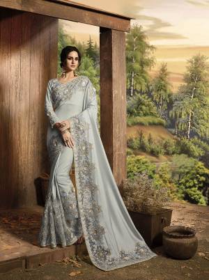 Get Ready For The Upcoming Wedding Season With This Heavy Designer Saree In Grey Color Paired With Grey Colored Blouse. This Saree Is Fabricated On Soft Silk And Net Paired With Art Silk Fabricated Blouse. It Is Beautified With Attractive Fancy Embroidery Over The Saree Border And Blouse. 