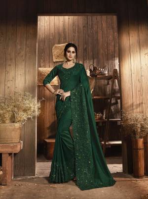 Adorn The Angelic Look With This Appealing Colored Heavy Designer Saree In Forest Green Color. This Saree Is Fabricated On Soft Silk Paired With Art Silk Fabricated Blouse. It IS Beautified With Subtle Tone To Tone Embroidery Which Gives More Elegant Look All Over The Saree. 