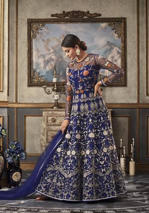 Shine Bright Wearing This Heavy Designer Floor Length Suit In Royal Blue Color Paired With Royal Blue Colored Bottom And Dupatta. Its Top And Dupatta Are Net Fabricated Paired With Art Silk Bottom And Inner. Its top Is Beautified With Heavy Contrasting Work All Over. 