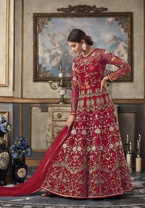 Shine Bright Wearing This Heavy Designer Floor Length Suit In Red Color Paired With Red Colored Bottom And Dupatta. Its Top And Dupatta Are Net Fabricated Paired With Art Silk Bottom And Inner. Its top Is Beautified With Heavy Contrasting Work All Over. 