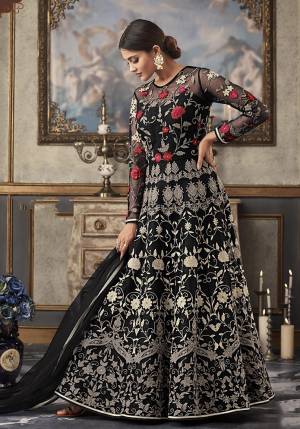 Shine Bright Wearing This Heavy Designer Floor Length Suit In Black Color Paired With Black Colored Bottom And Dupatta. Its Top And Dupatta Are Net Fabricated Paired With Art Silk Bottom And Inner. Its top Is Beautified With Heavy Contrasting Work All Over. 