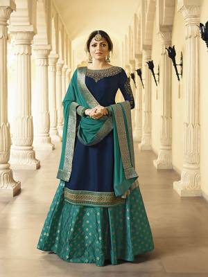 Enhance Your Personality Wearing This Designer Indo-Western Suit In Navy Blue Colored Top Paired With Turquoise Blue Colored Bottom And Dupatta. Its Embroidered Top Is Fabricated On Satin Georgette Paired With Brocade Bottom And Chiffon Fabricated Dupatta. Its Attractive Embroidery Over Neckline Gives A Very Graceful Look. 