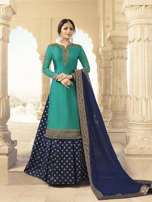 Enhance Your Personality Wearing This Designer Indo-Western Suit In Turquoise Blue Colored Top Paired With Navy Blue Colored Bottom And Dupatta. Its Embroidered Top Is Fabricated On Satin Georgette Paired With Brocade Bottom And Chiffon Fabricated Dupatta. Its Attractive Embroidery Over Neckline Gives A Very Graceful Look. 