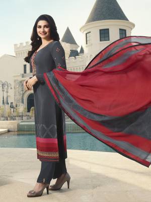 Flaunt Your Rich And Elegant Taste Wearing This Designer Suit In Grey Color Paired With Red And Grey Colored Dupatta. This Dress Material Is Crepe Based Paired With Chiffon Fabricated Dupatta. It Is Light Weight And Soft Towards Skin Which Is Easy To CArry All Day Long. 