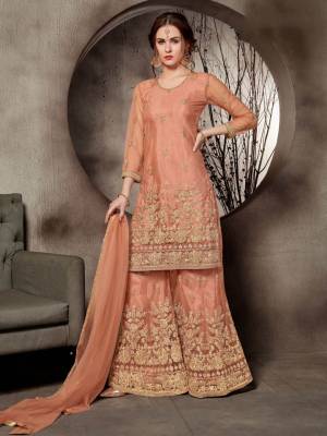 Look Pretty In This Designer Heavy Embroidered Sharara Suit In All Over Dark Peach Color. Its Top, Bottom And Dupatta Are Fabricated On Net Beautified With Heavy Jari Embroidery And Stone Work. Buy This Pretty Suit Now.