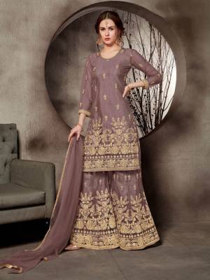 Look Pretty In This Designer Heavy Embroidered Sharara Suit In All Over Mauve Color. Its Top, Bottom And Dupatta Are Fabricated On Net Beautified With Heavy Jari Embroidery And Stone Work. Buy This Pretty Suit Now.