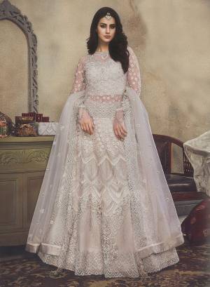 Simple And Elegant Looking Heavy Designer Lehenga Choli Is Here With Off-White Color. This Whole Lehenga Choli Is Net Based Beaitified With Pretty Tone To Tone Embroidery Giving It An Elegant Look.  Buy This Lehenga Choli Now.