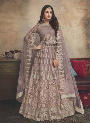 New And Rich Shade Is Here With This Heavy Designer Lehenga Choli In Shade Of Purple And Grey That Is Mauve Color. This Pretty Heavy Embroidered Lehenga Choli Is Fabricated On Net. Its Pretty Color And Attractive Embroidery Will Earn You Lots Of Compliments From Onlookers. 