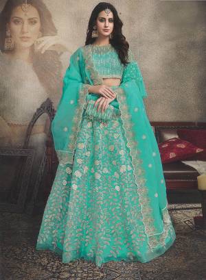 This Wedding Season, Look The Most Amazing Of All Wearing This Heavy Designer Lehnega Choli In Sea Green Color. This Over All Lehenga Choli And Dupatta Are Fabricated On Orgenza Beautified With Pretty Embroidery Which Gives A Rich And Subtle Look. 