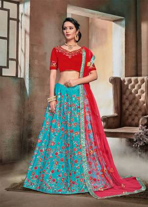 Catch All The Limelight Wearing This Heavy Designer Lehenga Choli In Red Colored Blouse And Dupatta Paired With Contrasting Blue Colored Lehenga. This Heavy Embroidered Lehnega Choli Is Fabricated On Nylon Satin Paired With Net Fabricated Dupatta. 