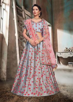 Flaunt Your Rich And Elegant Taste Wearing This Heavy Designer Lehenga Choli In Grey Color Paired With Contrasting Baby Pink Colored Dupatta. This Heavy Embroidered Lehenga Choli Is Fabricated On Nylon Satin Paired With Net Fabricated Dupatta. Buy This Now. 