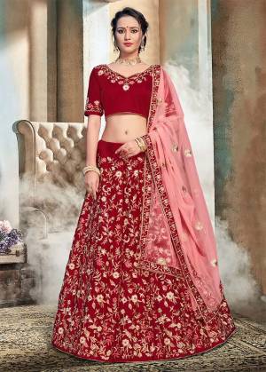 Get Ready For The Upcoming Wedding Season With This Heavy Embroidered Lehenga Choli In Maroon Color Paired With Contrasting Pink Colored Dupatta. Its Blouse And Lehenga Are Fabricated On Nylon Satin Paired With Net Fabricated Dupatta. Buy This Attractive Looking Lehenga Choli Now.