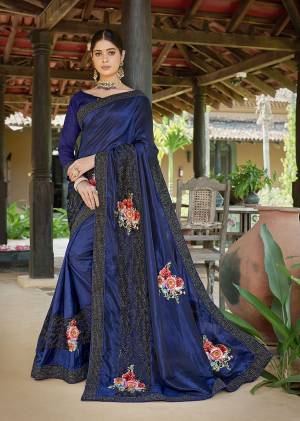 Bright And Visually Appealing Color Is Here With This Designer Saree In Dark Blue Color Paired With Dark Blue Colored Blouse. This Saree Is Fabricated On Satin Silk Paired With Art Silk Fabricated Blouse. It Is Beautified With Floral Printed Patches And Embroidery Giving The Saree A More Attractive Look. 