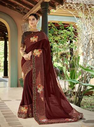 Enhance Your Personality Wearing This Designer Saree In Brown Color Paired With Brown Colored Blouse. This Saree Is Georgette Based Paired With Art Silk Fabricated Blouse. It Is Light Weight And Highlighted With Floral Printed Patches And Embroidery. 