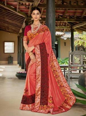 Bright And Visually Appealing Color Is Here With This Designer Saree In Orange Color Paired With Red Colored Blouse. This Saree Is Fabricated On Satin Silk Paired With Art Silk Fabricated Blouse. It Is Beautified With Floral Printed Patches And Embroidery Giving The Saree A More Attractive Look. 