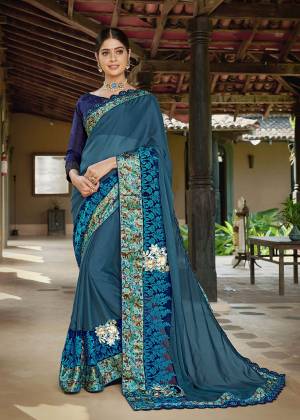 Catch All The Limelight Wearing This Designer Saree In Blue Color Paired With Royal Blue Colored Blouse. This Saree Is Fabricated On Georgette Paired With Art Silk Fabricated Blouse. It Is Beautified With Floral Printed Patches And Embroidery. 