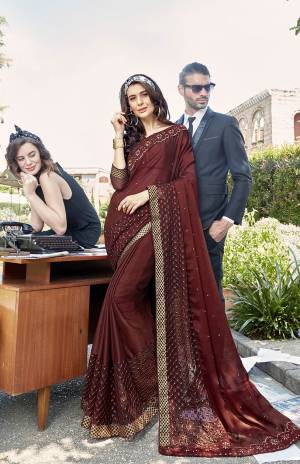 Add This Beautiful Designer Saree To Your Wardrobe In Brown Color Paired With Brown Colored Blouse. This Pretty Tone To Tone Embroidered Saree Is Georgette Based Paired With Art Silk Fabricated Blouse. It Is Light In Weight And Easy To Carry All Day Long. 