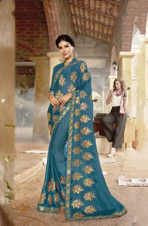 Add This Beautiful Designer Saree To Your Wardrobe In Turquoise Blue Color Paired With Turquoise Blue Colored Blouse. This Pretty Attractive Embroidered Saree Is Georgette Based Paired With Art Silk Fabricated Blouse. It Is Light In Weight And Easy To Carry All Day Long. 