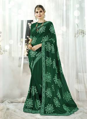 Celebrate This Festive Season With Beauty And Comfort Wearing This Designer Saree In Dark Green Color. This Saree And Blouse Are Fabricated On Georgette Beautified With Contrasting Resham Embroidery All Over. Buy Now.