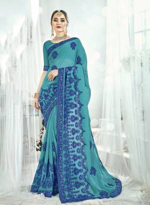 Grab This Attractive Looking Designer Saree In Turquoise Blue Color Paired With Turquoise Blue Colored Blouse. This Saree And Blouse are Georgette Based Beautified with Contrasting Resham Embridery And Stone Work. 