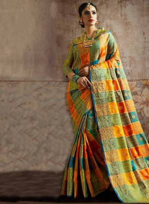 Go Colorful With This Designer Silk Based Saree In Multi Color Paired With Green Colored Blouse. This Saree And Blouse Are Fabricated On Art Silk beautified With Attractive Weave In Checks Pattern. Buy Now.