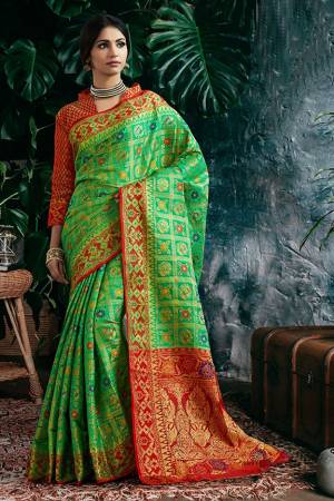 Celebrate This Festive With Beauty And Comfort Wearing This Designer Heavy Weaved Saree In Green Color Paired With Contrasting Red Colored Blouse. This Saree And Blouse Are Fabricated On Art Silk Beautified With Weave All Over. 