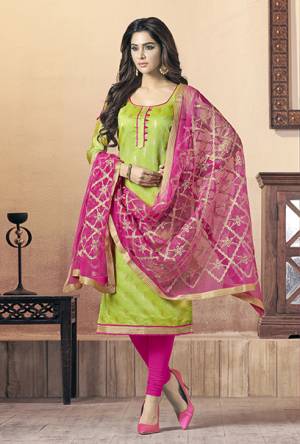 Celebrate This Festive Season With Beauty And Comfort With This Dress, Get This Stitched As Per Your Desired Fit And Comfort. Its Top Is In Light Green Color Paired With Contrasting Rani Pink Colored Bottom And Dupatta. Its Top Is Fabricated On Soft Banarasi Jacquard Paired With Cotton Bottom And Chiffon Fabricated Embroidered Dupatta. 