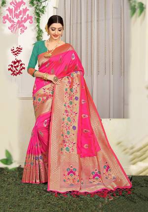Bright And Visually Appealing Color Is Here With This Designer Silk Based Saree In Rani Pink Color Paired With Contrasting Sea Green Colored Blouse. This Saree Is Jacquard Silk Based Beautified With Heavy Weave Paired With Art Silk Fabricated Blouse. 